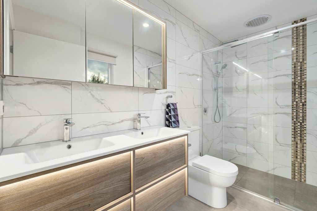 A bathroom with a toilet, sink, and shower